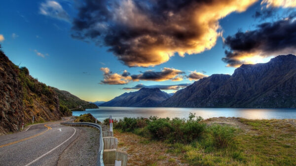 Wallpaper Sky, River, Bushes, Road, Grass, Green, Between, Mountains, Under, Nature, White, Fence, Black, And, Rock, Clouds, With, Blue